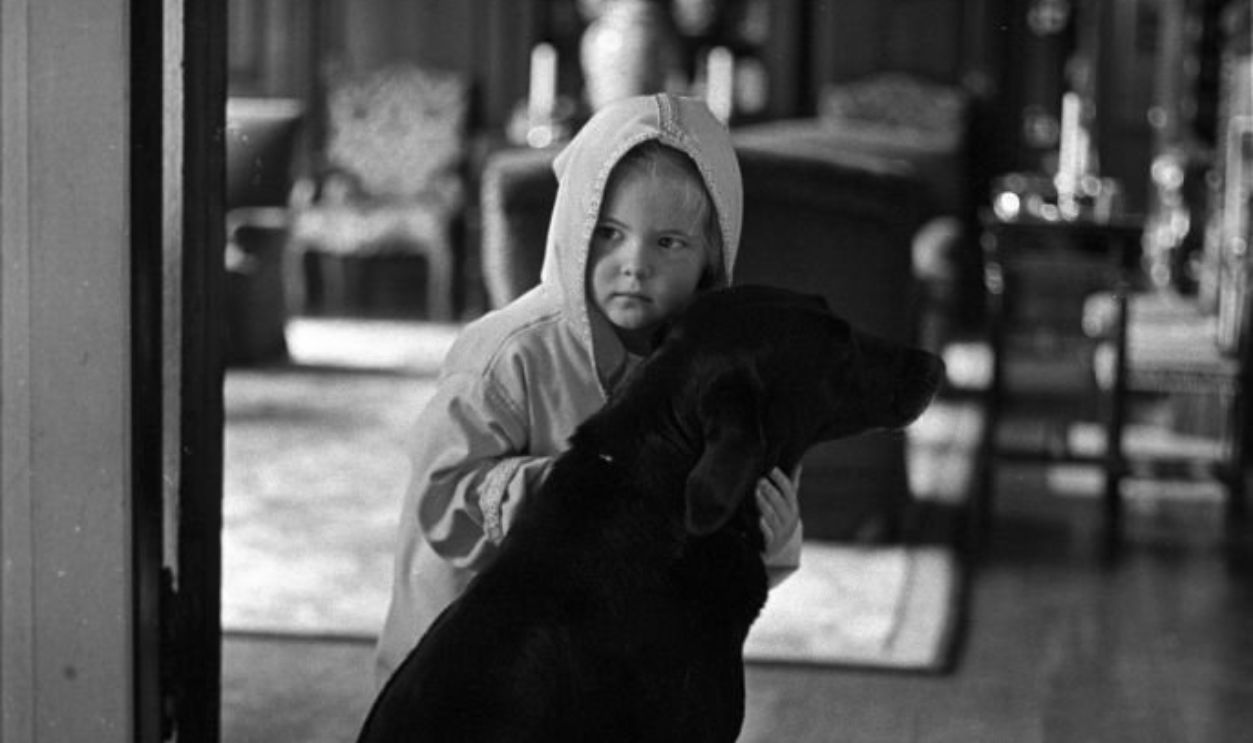 Cornelia Guest, daughter of C.Z. Guest, as a toddler at home with her pet dog