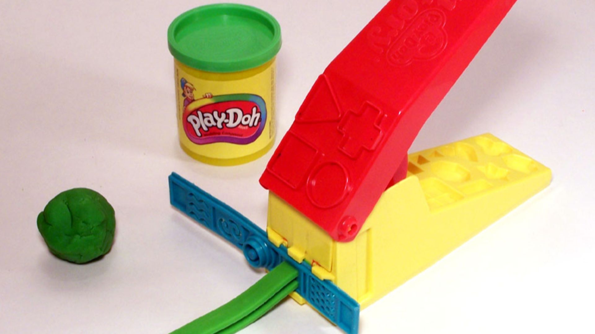 Green Play-Doh with can and accessory toy  (Play-Doh is a trademark of Hasbro).