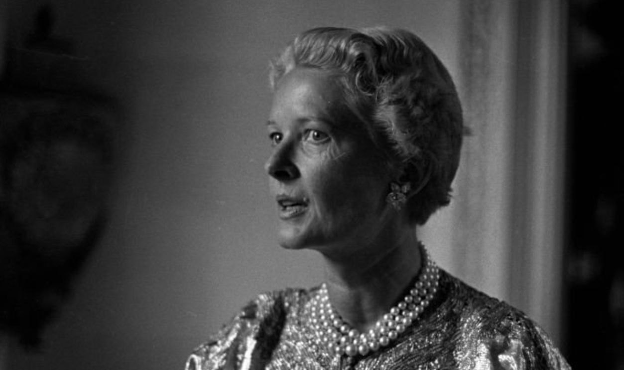 CZ Guest at home wearing a pearl necklace and elegant caftan