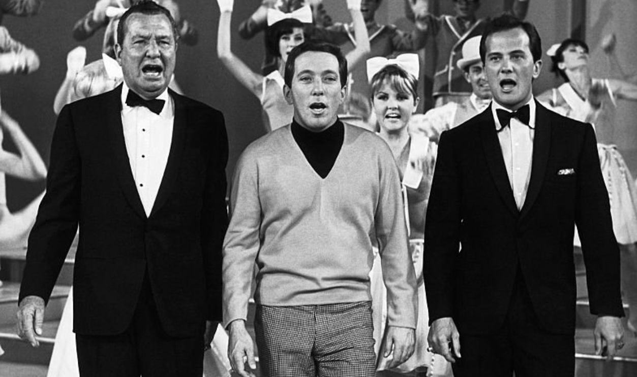 (Original Caption) Andy Williams (C) and guest stars Phil Harris (L) and Pat Boone are shown singing