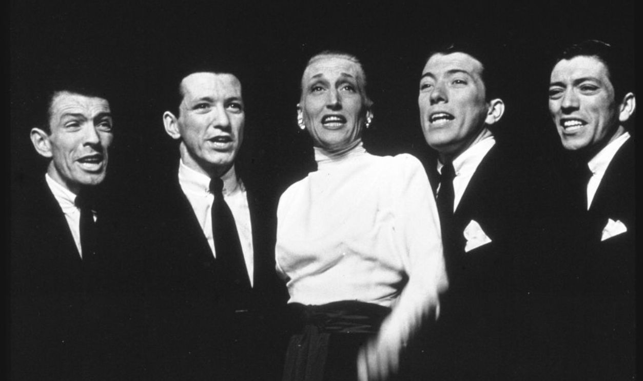 Entertainer Kay Thompson (C) with vocalist Andy Williams (2R) and his brothers performing on stage.