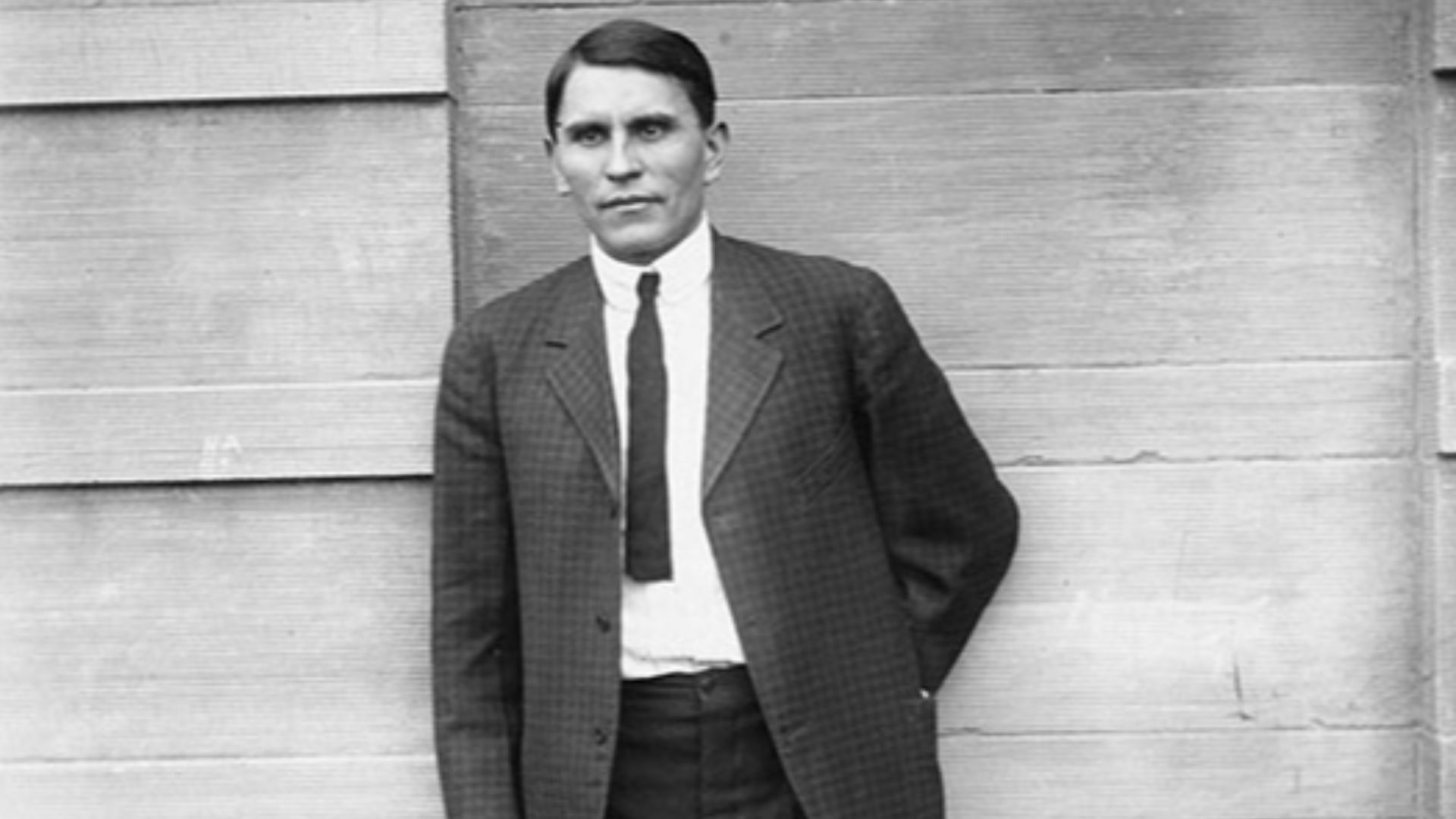 Henry Starr, American bank robber, standing outside a building.
(8667, Oklahoma Historical Society Photograph Collection, OHS).
