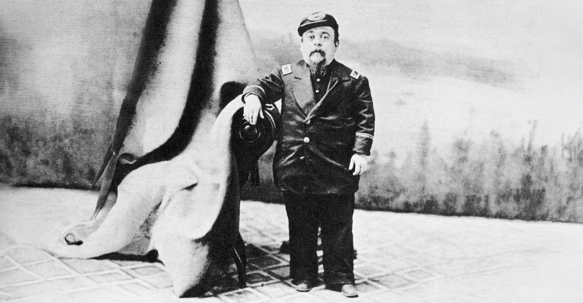 Charles Stratton standing beside a chair