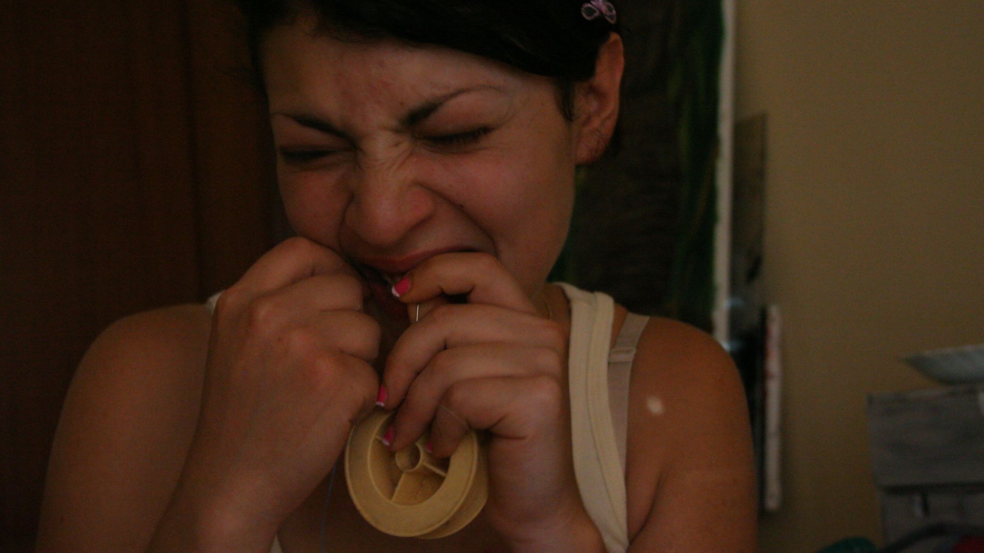 woman biting adhesive tape
