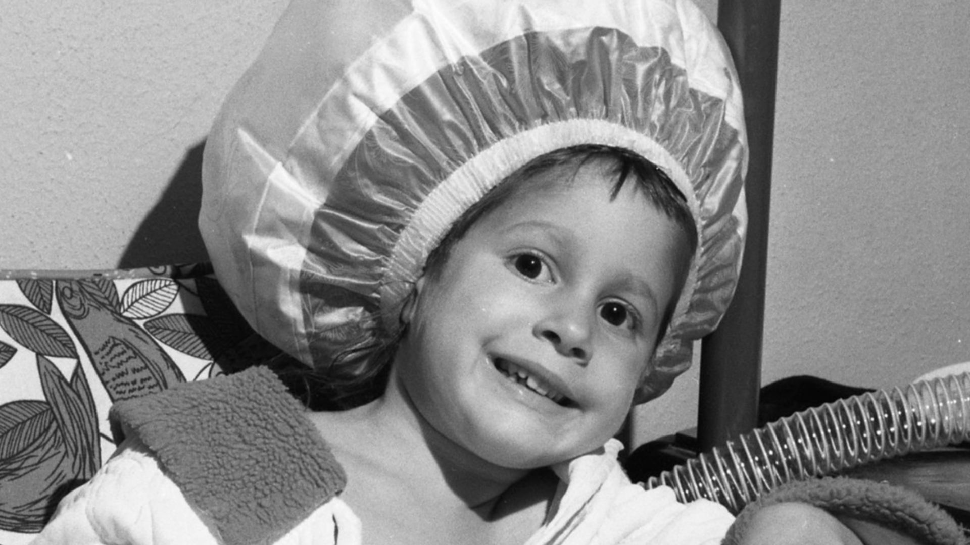 Girl using a bonnet-hood hair dryer, 1965