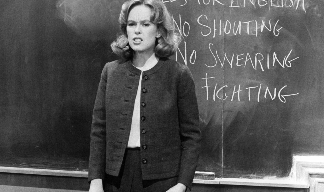Sandy Dennis posts classroom rules in a scene from the film 'Up The Down Staircase', 1967.