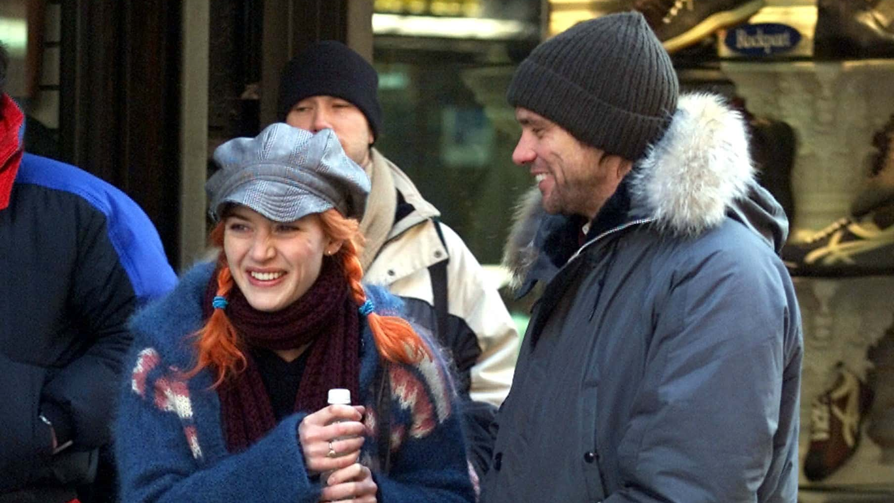 Actor Jim Carrey (R) and actress Kate Winslet stand on the movie set of 