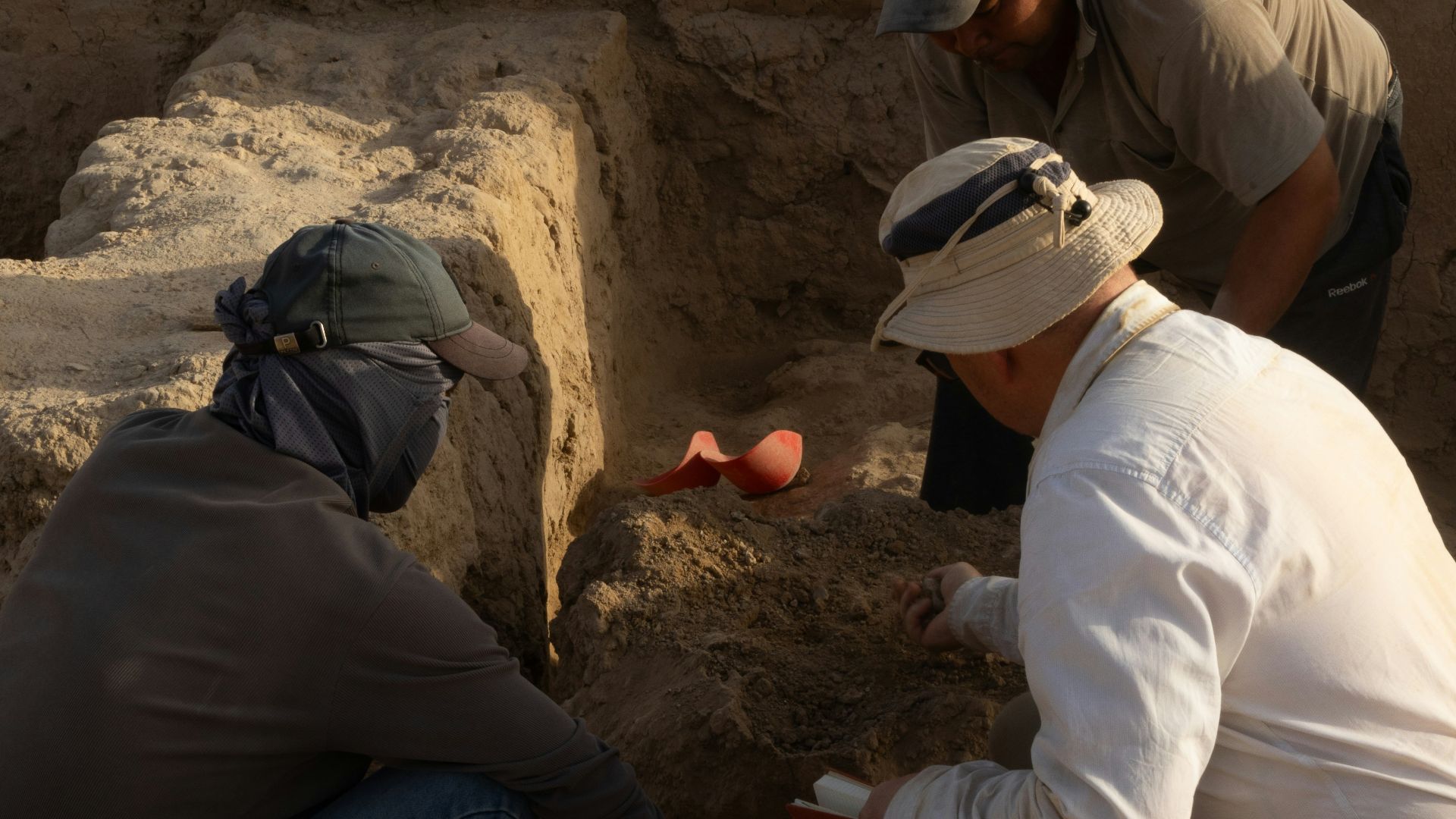 A group of men kneeling down next to each other
