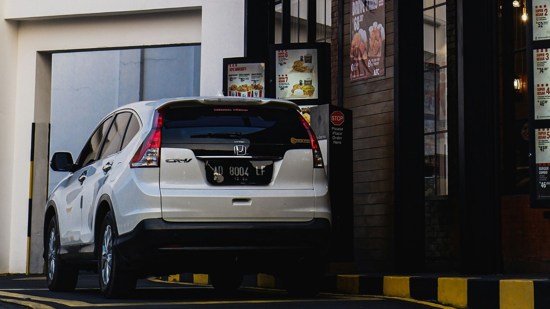 a car parked in front of a building with a solar panel on top of it
