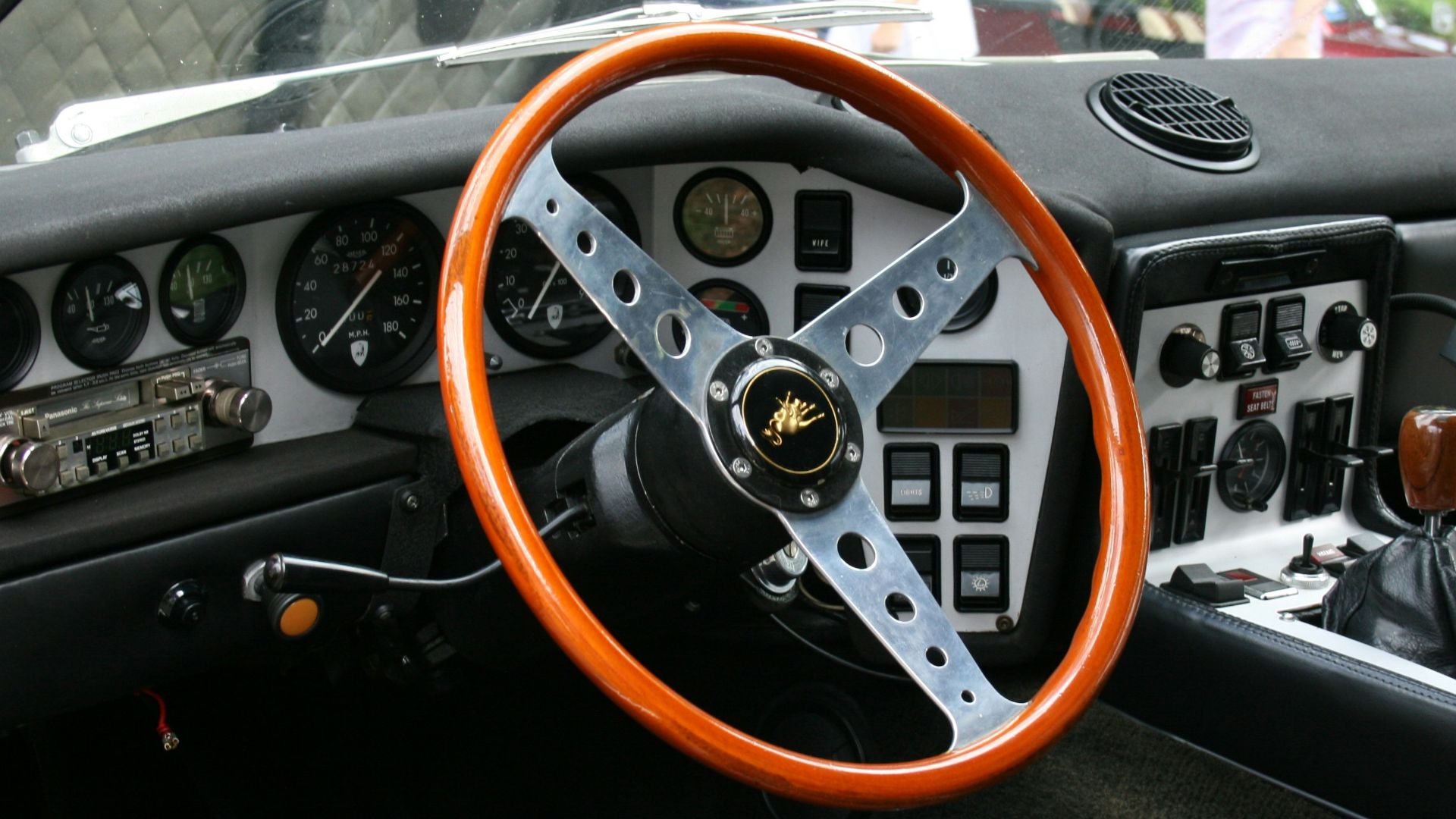 The interior of a car with a steering wheel and dashboard