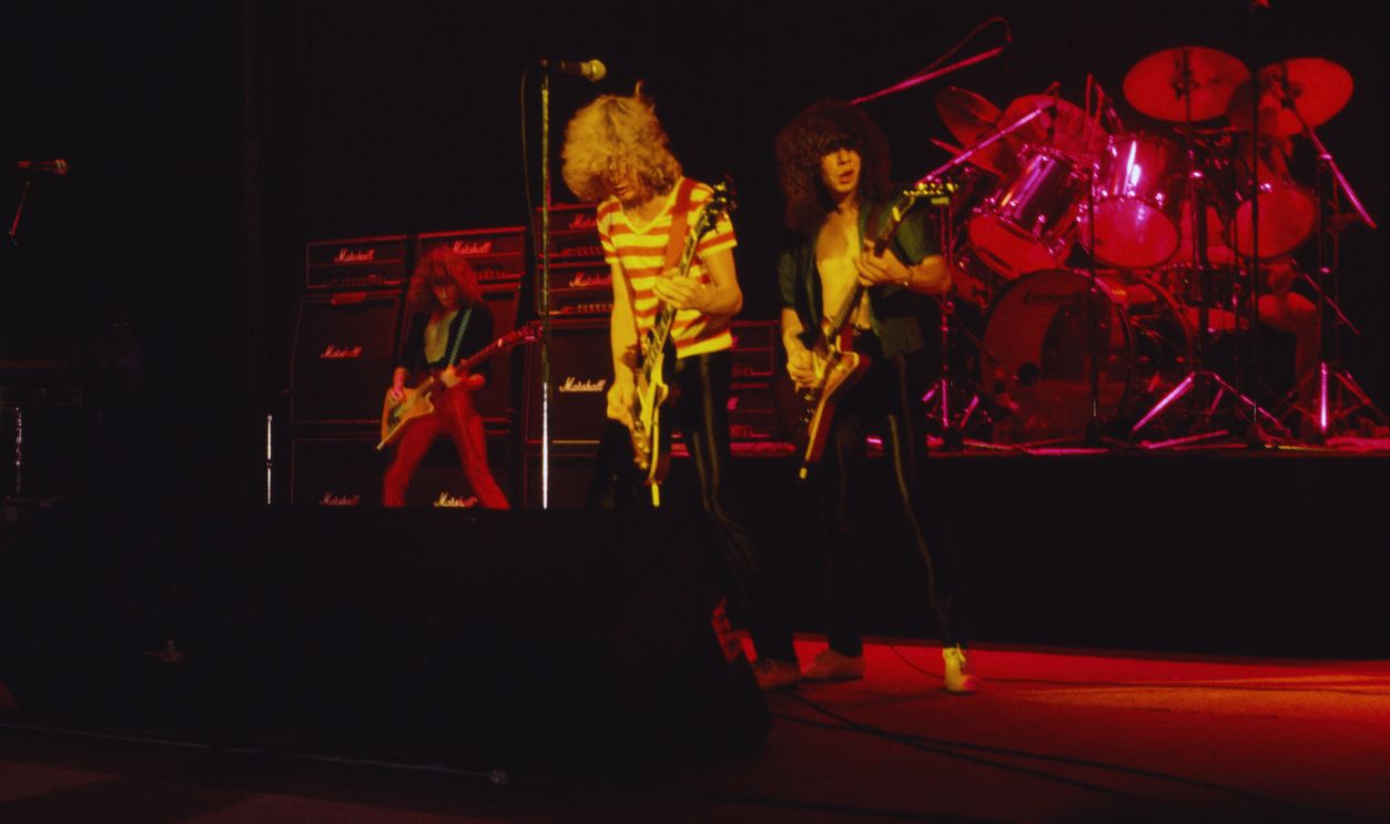Gettyimages - 1853057567, Def Leppard Performs At The Palladium Members of the English Rock group Def Leppard perform onstage at the Palladium, New York, New York, August 1, 1980. Pictured are, from left, Rick Savage, on bass guitar, Steve Clark (1960 - 1991) and Pete Willis, both on guitar, and Rick Allen (mostly obscured), on drums.