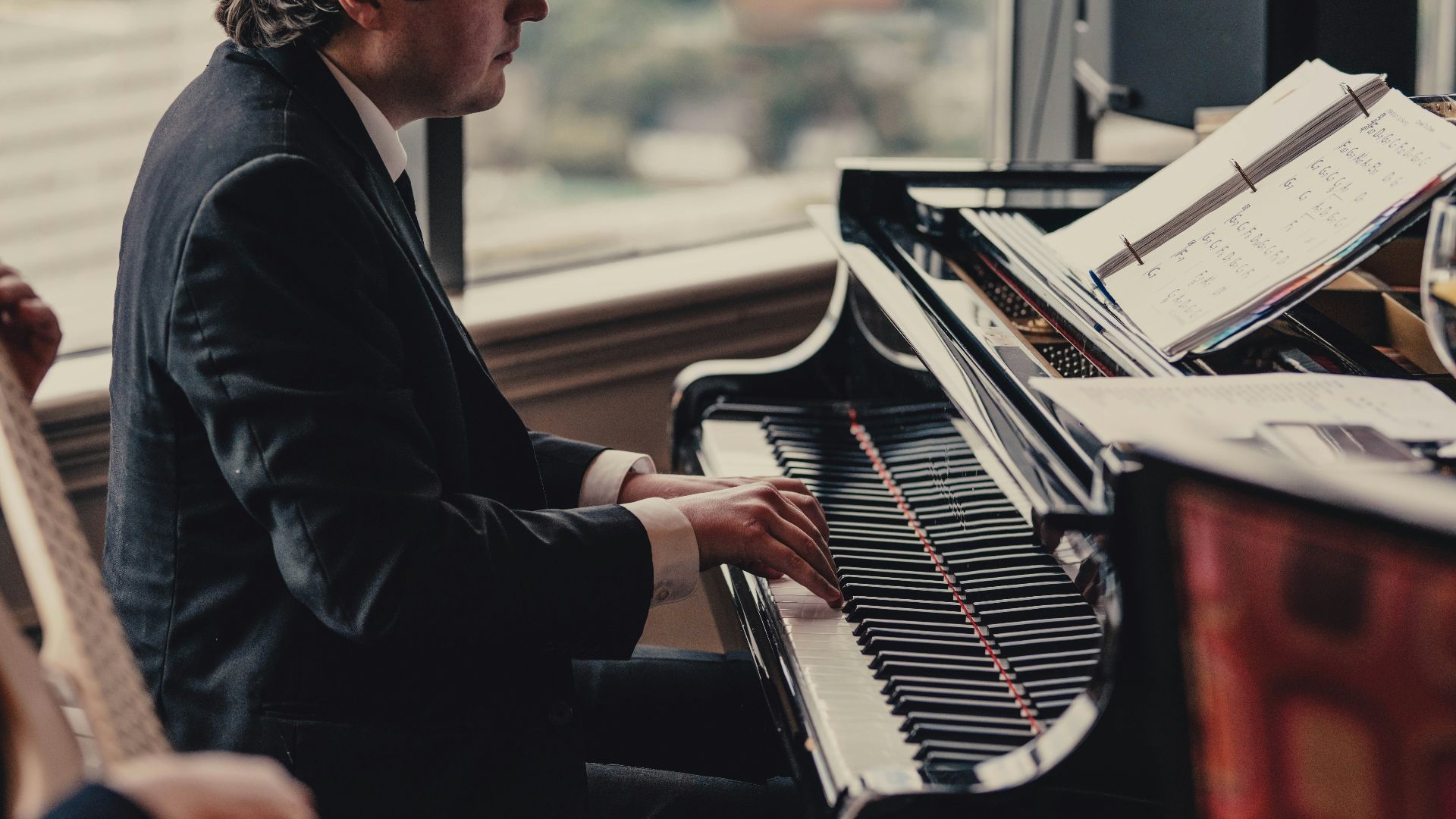 selective focus photography of person playing piano