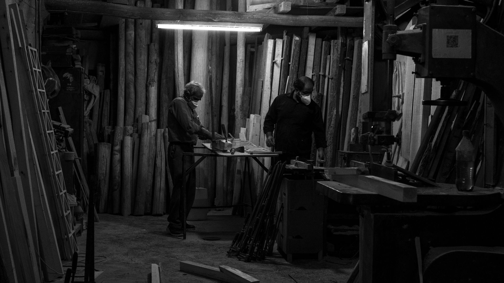 man in black jacket sitting on chair