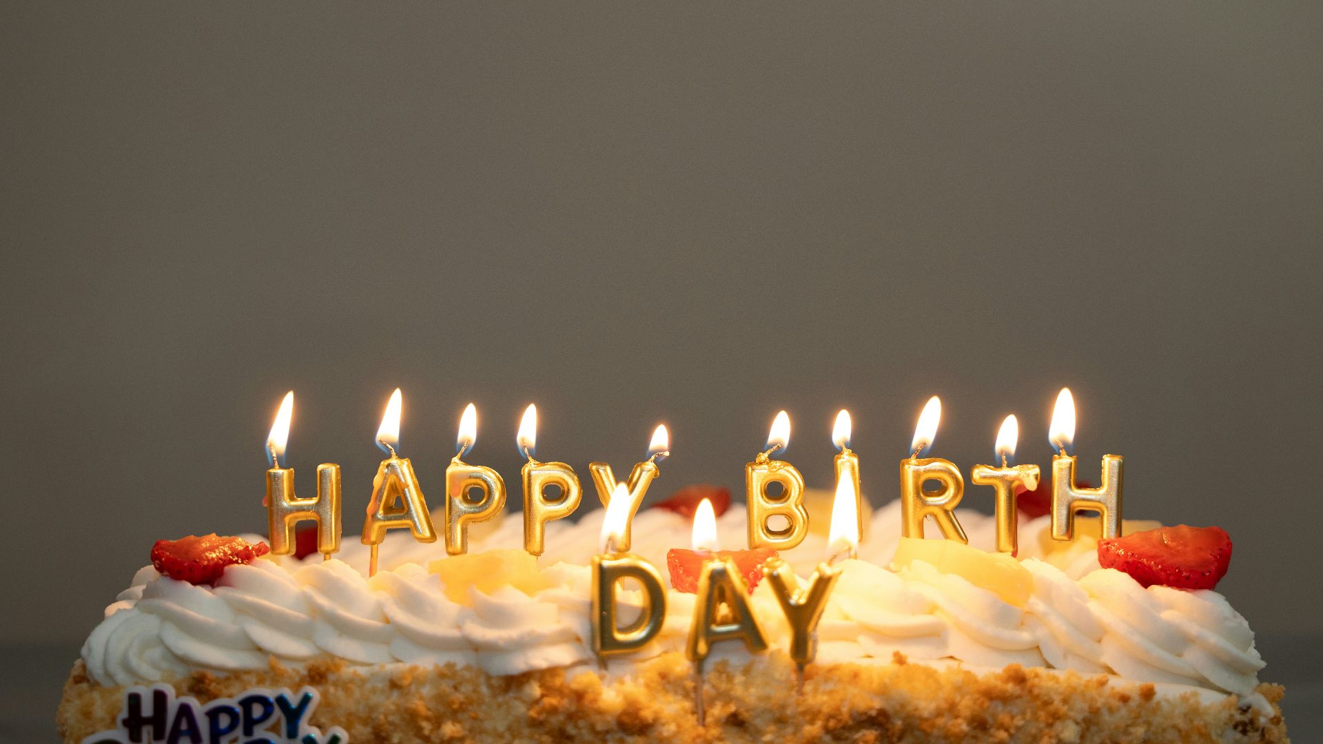A birthday cake with candles that say happy birthday day