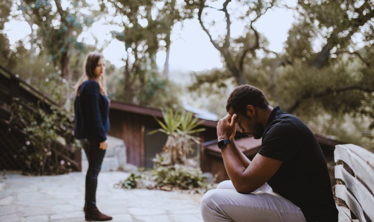 Woman Looking at the Stressed Man