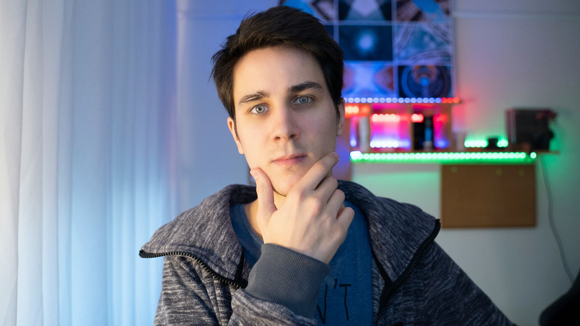 a young man is looking at the camera