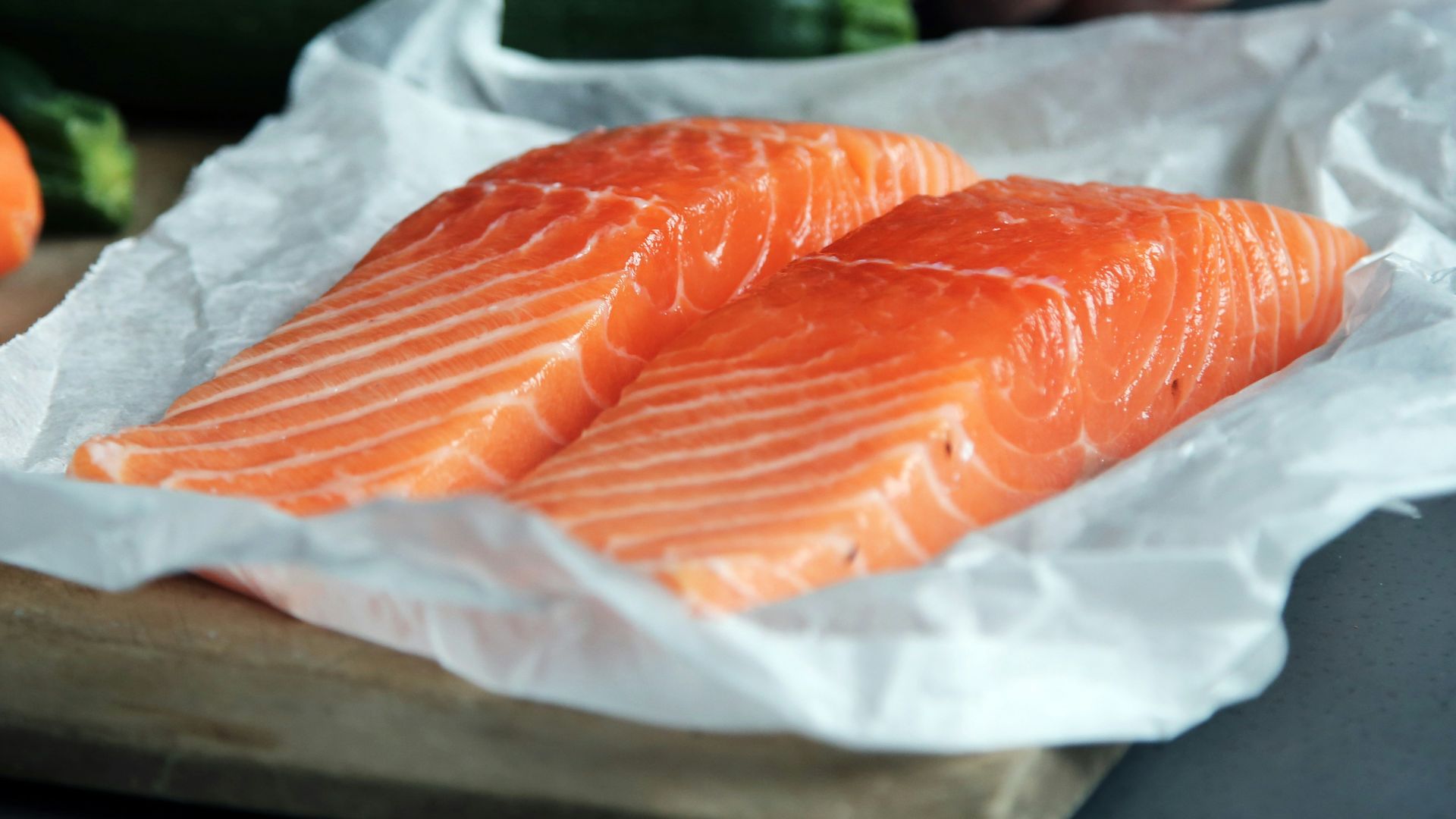 raw fish meat on brown chopping board