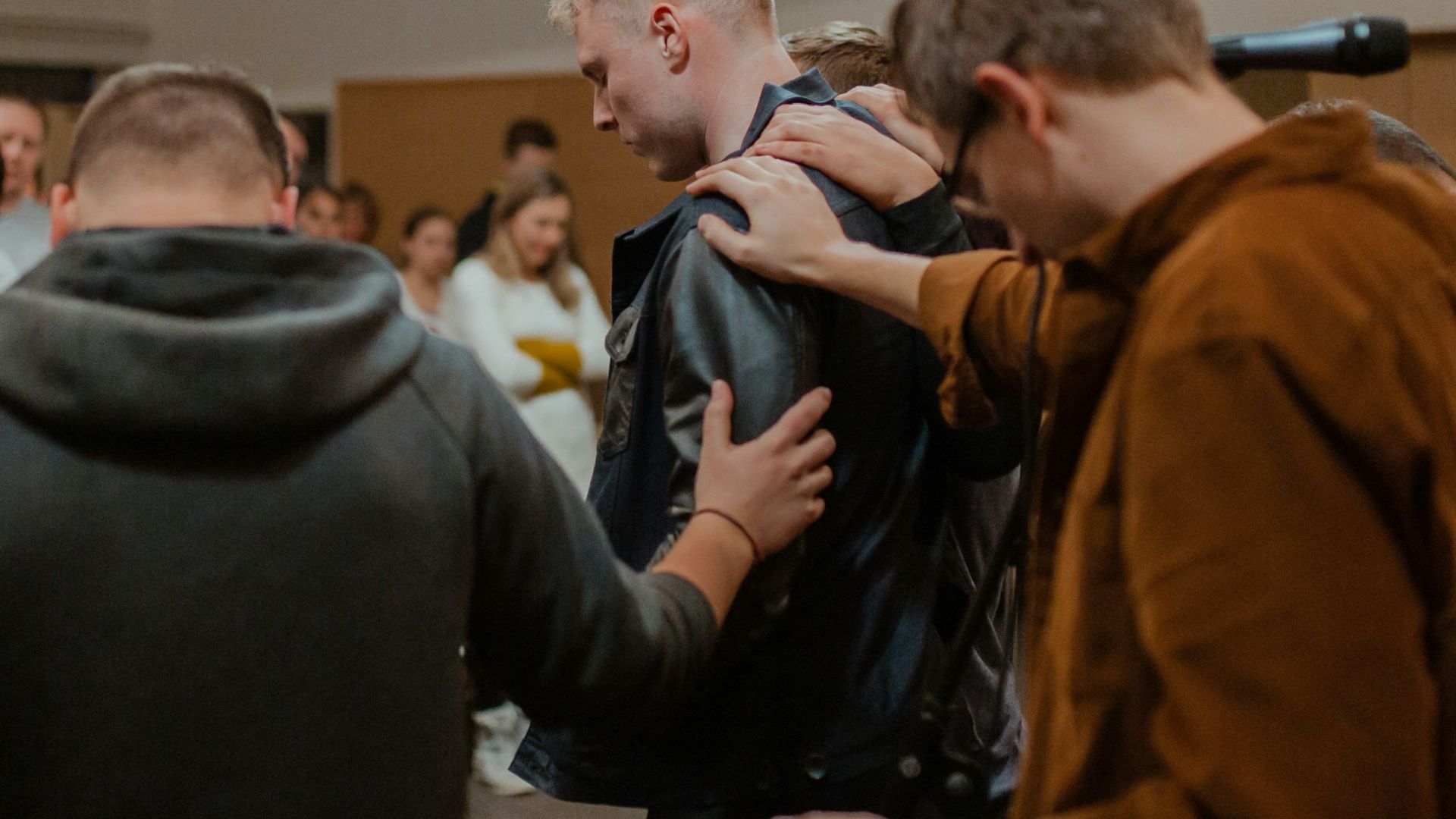 people in black and brown jackets standing in front of people