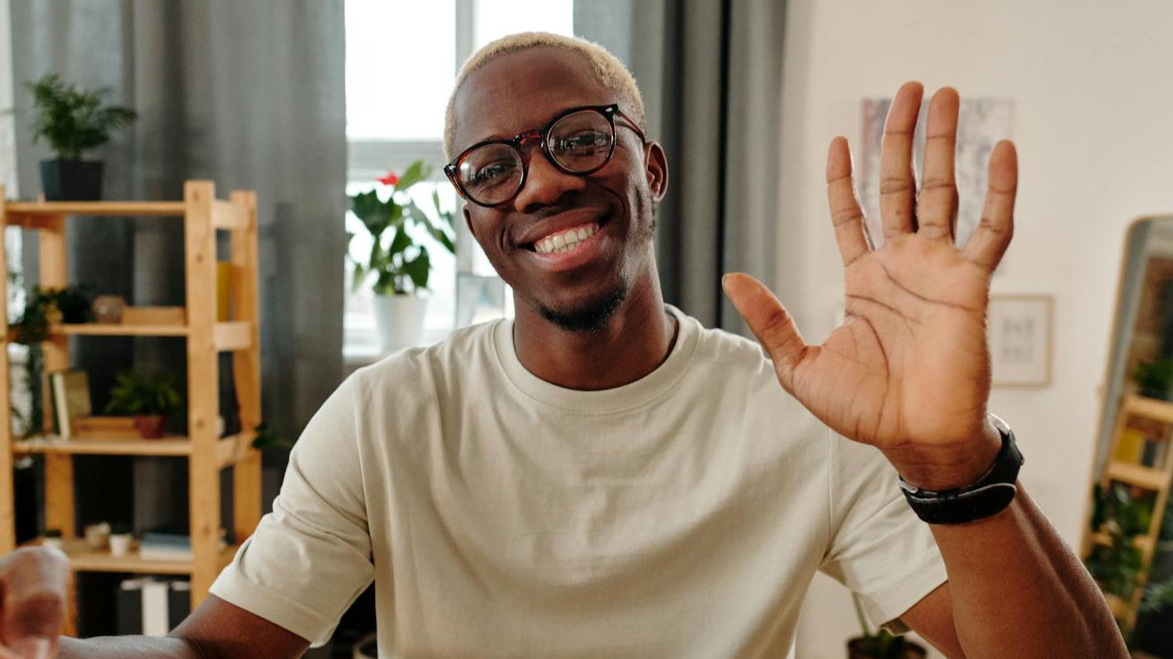 Man waving a hand