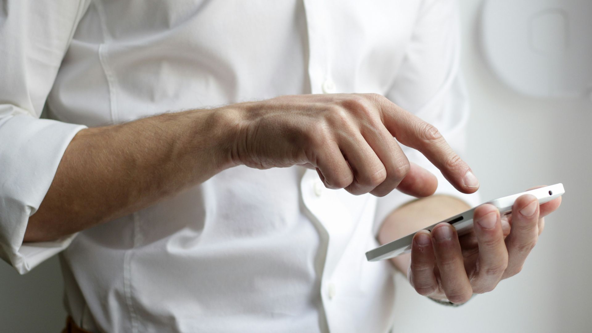 person holding white Android smartphone in white shirt
