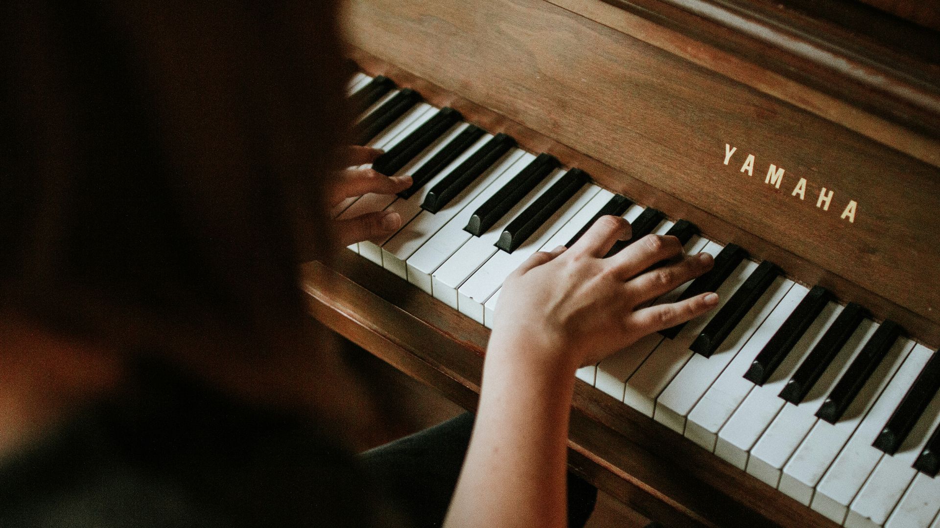 woman playing Yamaha piano