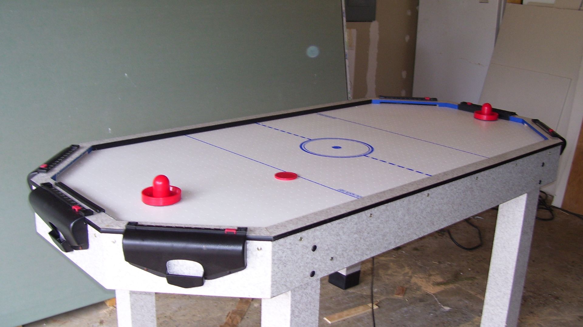 File:Air hockey table with puck and paddles.jpg