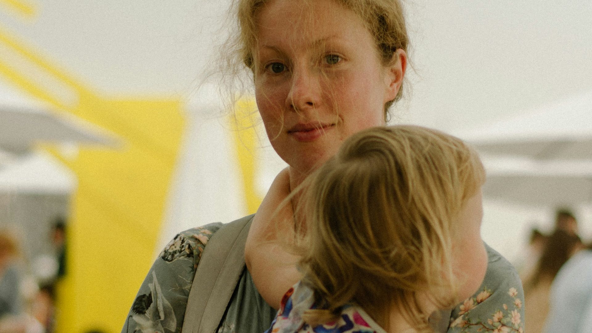 a woman holding a little girl in her arms