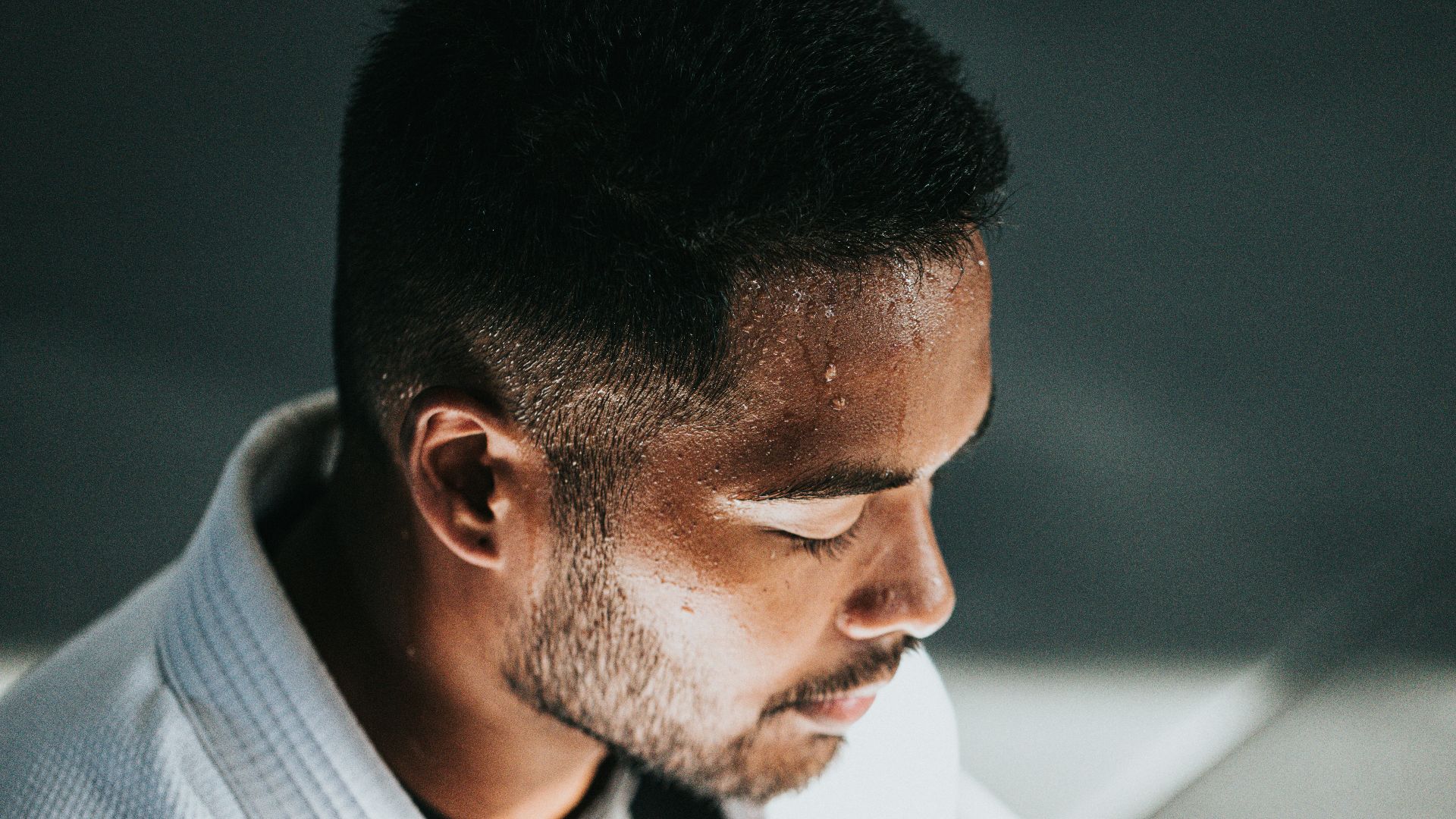 man in white shirt sitting on black chair