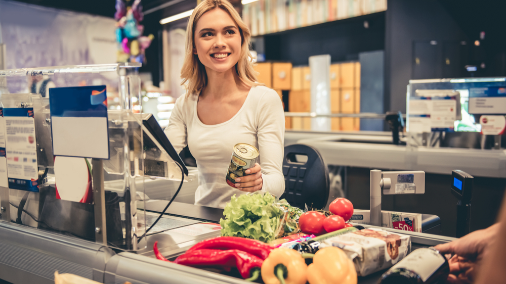 Beautiful young cashier  in white top