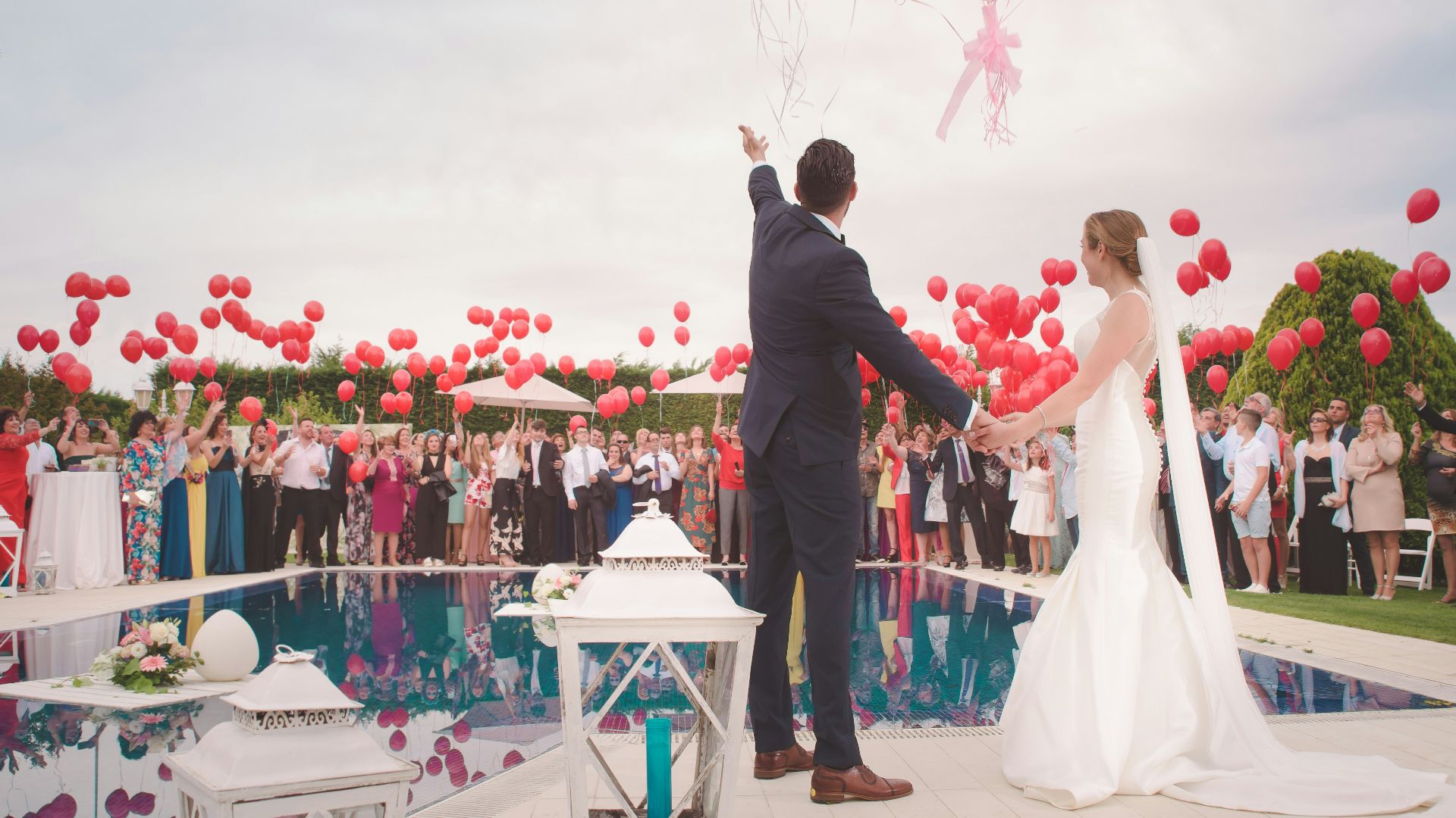 photo of a man and woman newly wedding holding a balloons