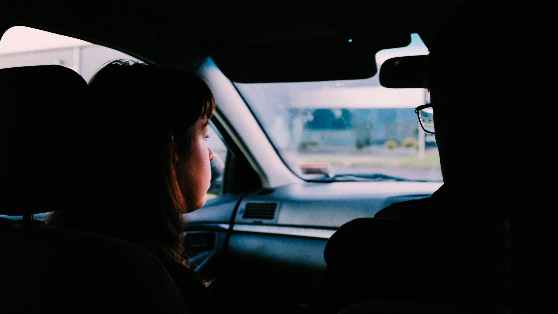 woman in black jacket sitting on car seat