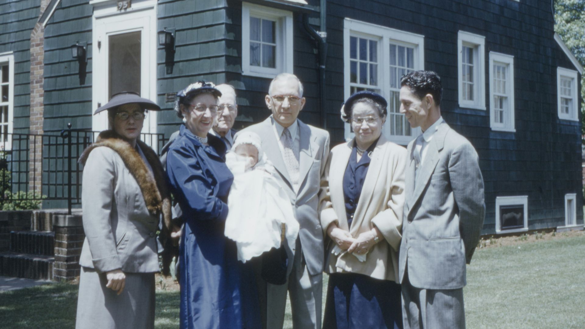 group of people standing near house