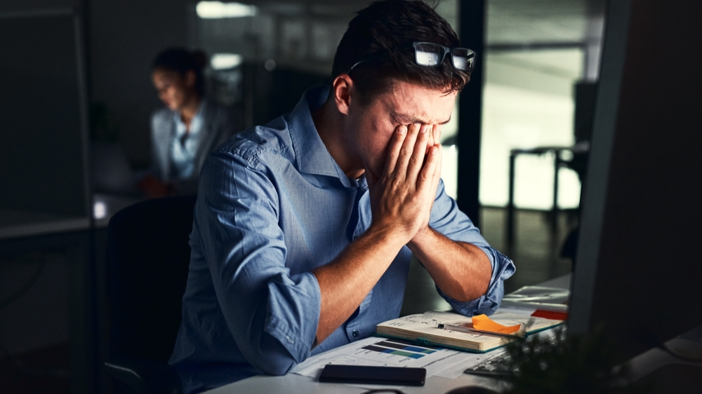 Portrait Photo of Man stressed in office at night
