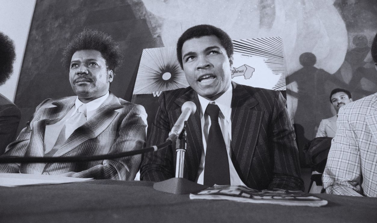 Gettyimages - 517724848, Muhammad Ali and Don King (Original Caption) (L to R) Don King, promoter boxing, Muhammad Ali, and Payne Lucas, ex director of AFRICARE, at U.N. press conference. 3/5/1975