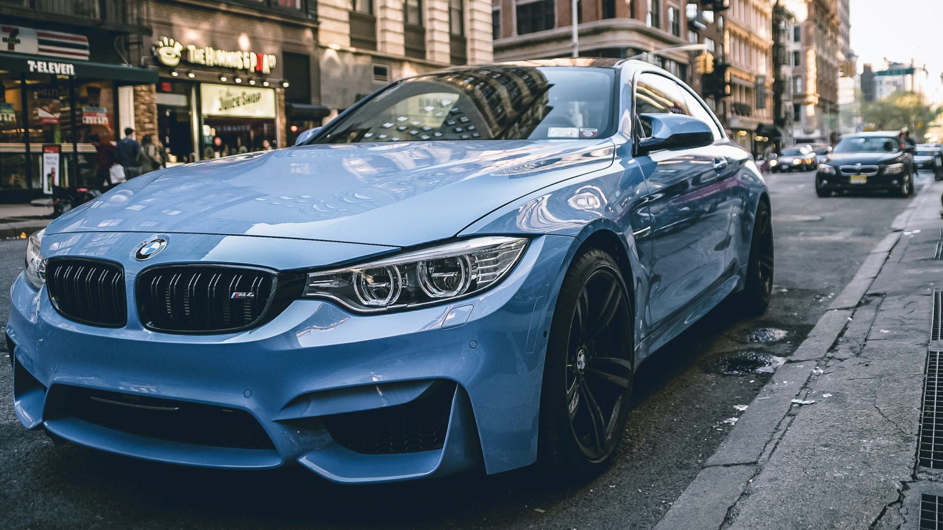 blue BMW coupe parked on the road during daytime