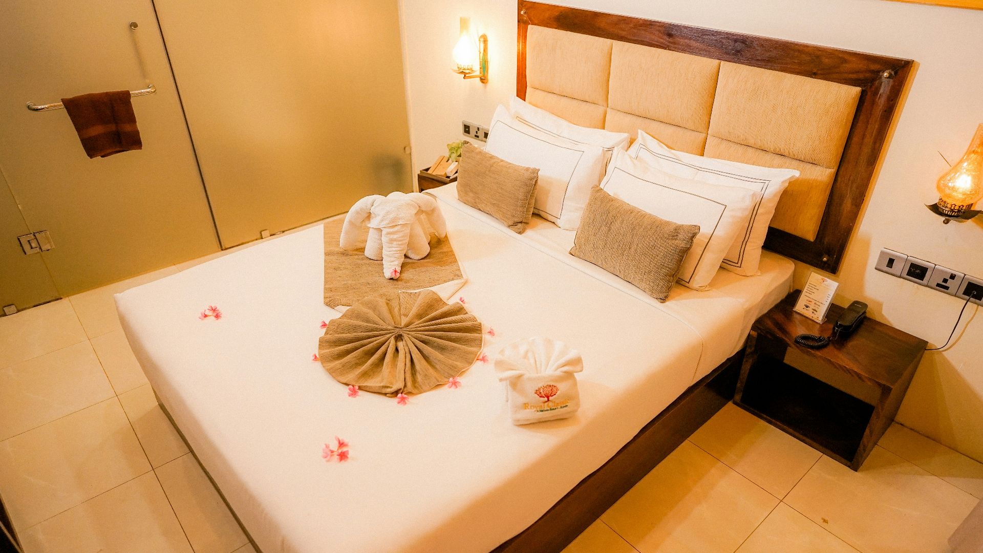 a bed with pillows and towels