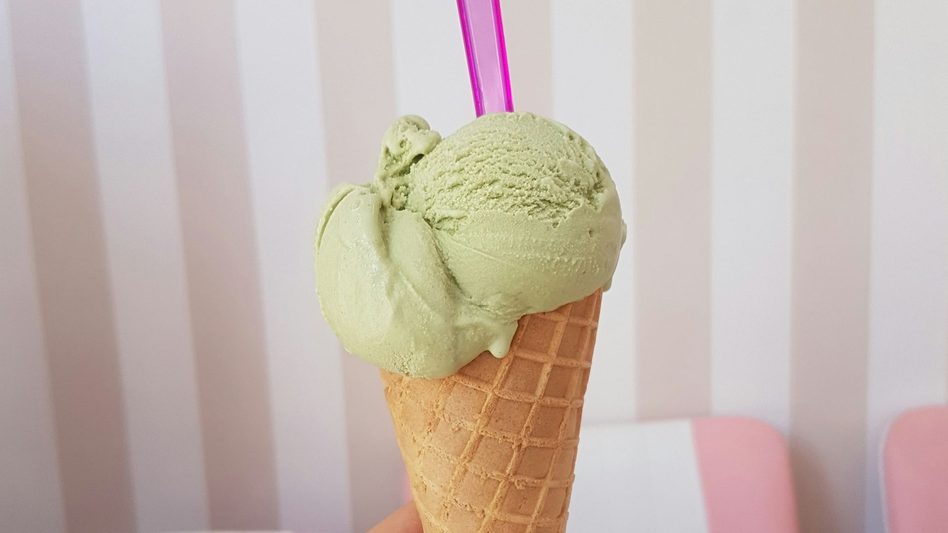 woman holding green ice cream