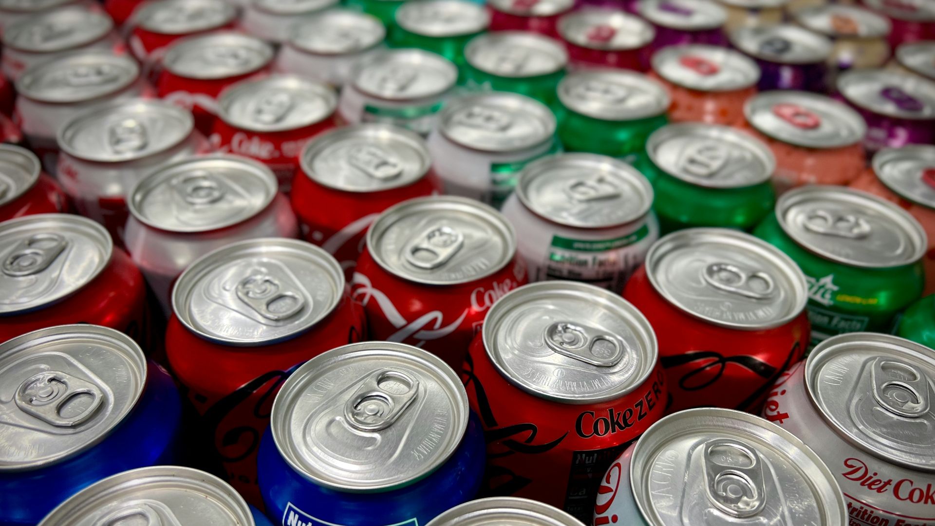 a large group of cans of soda