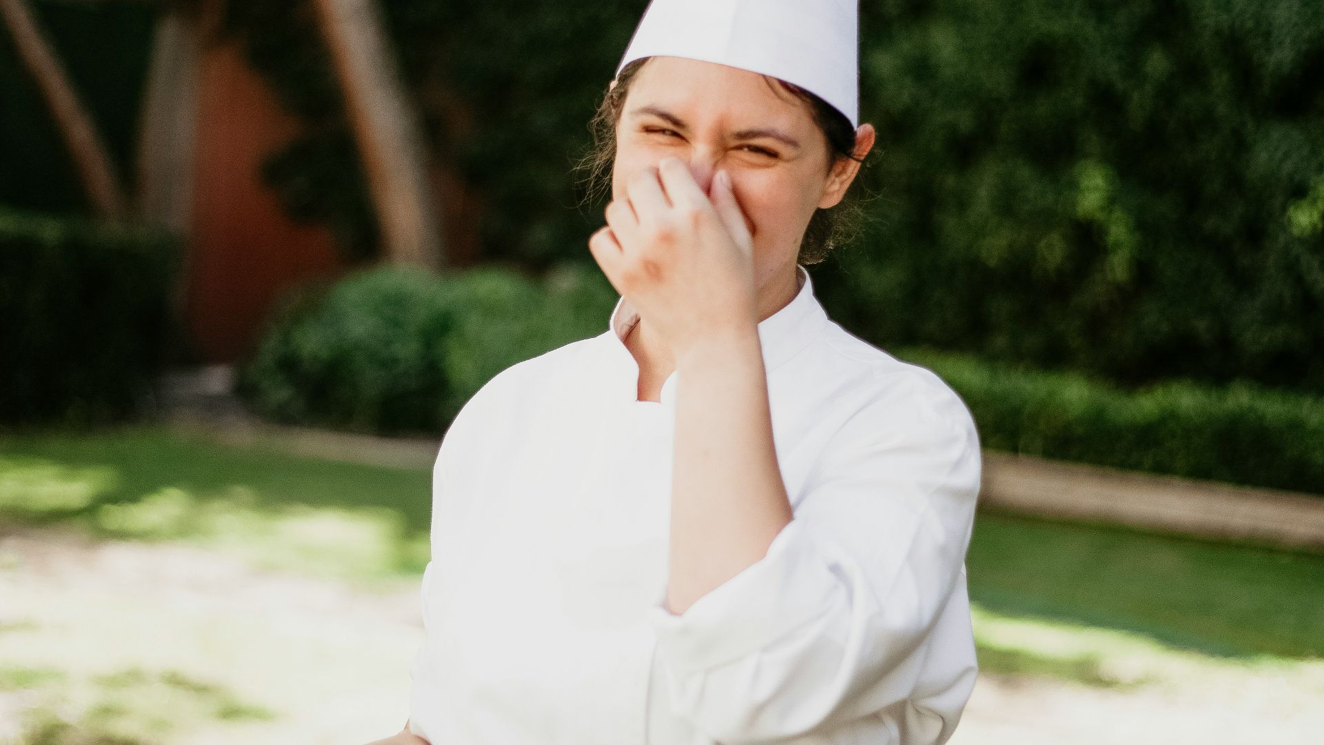 a woman dressed in a chef's outfit standing outside