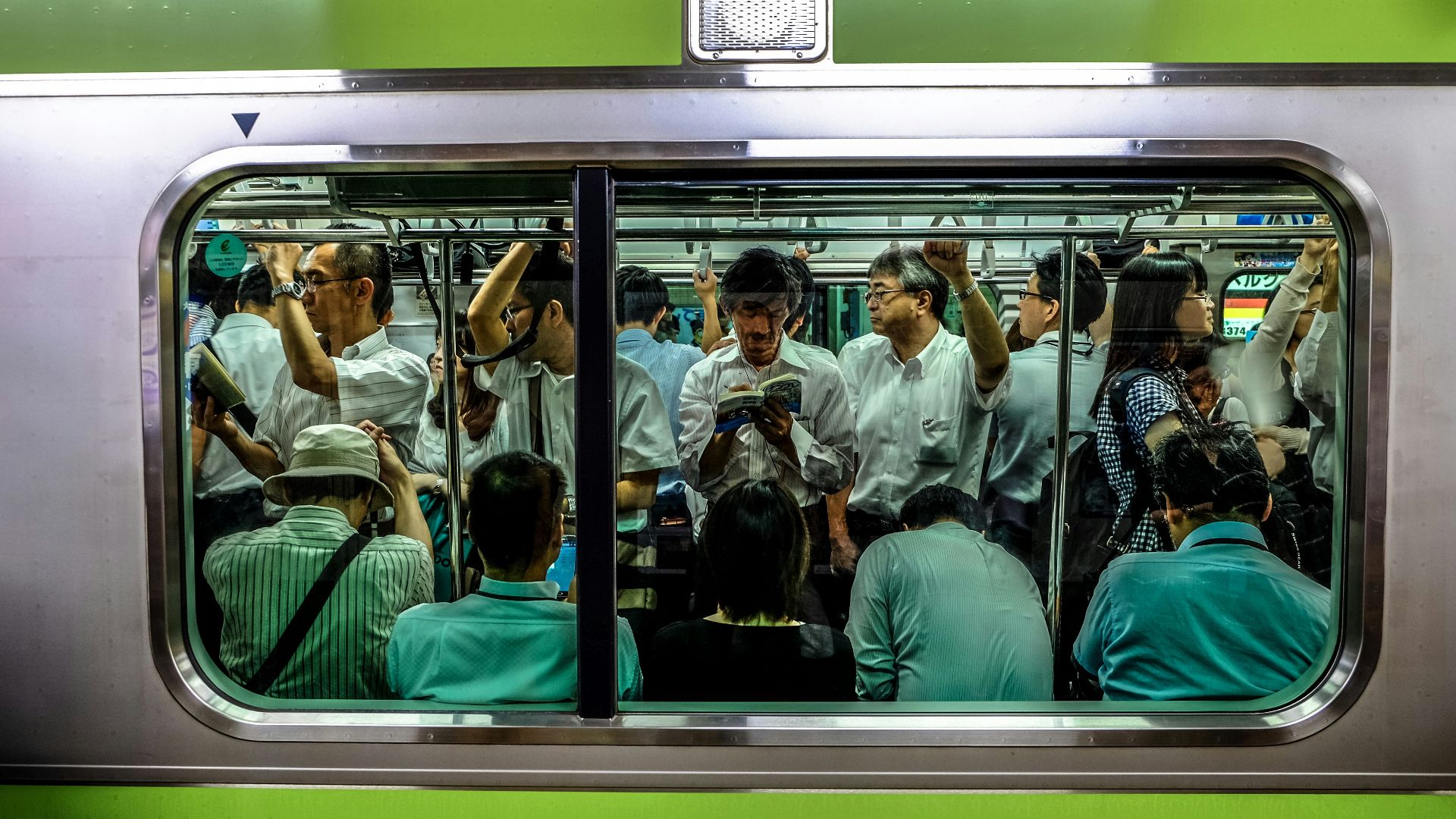people sitting and standing inside train