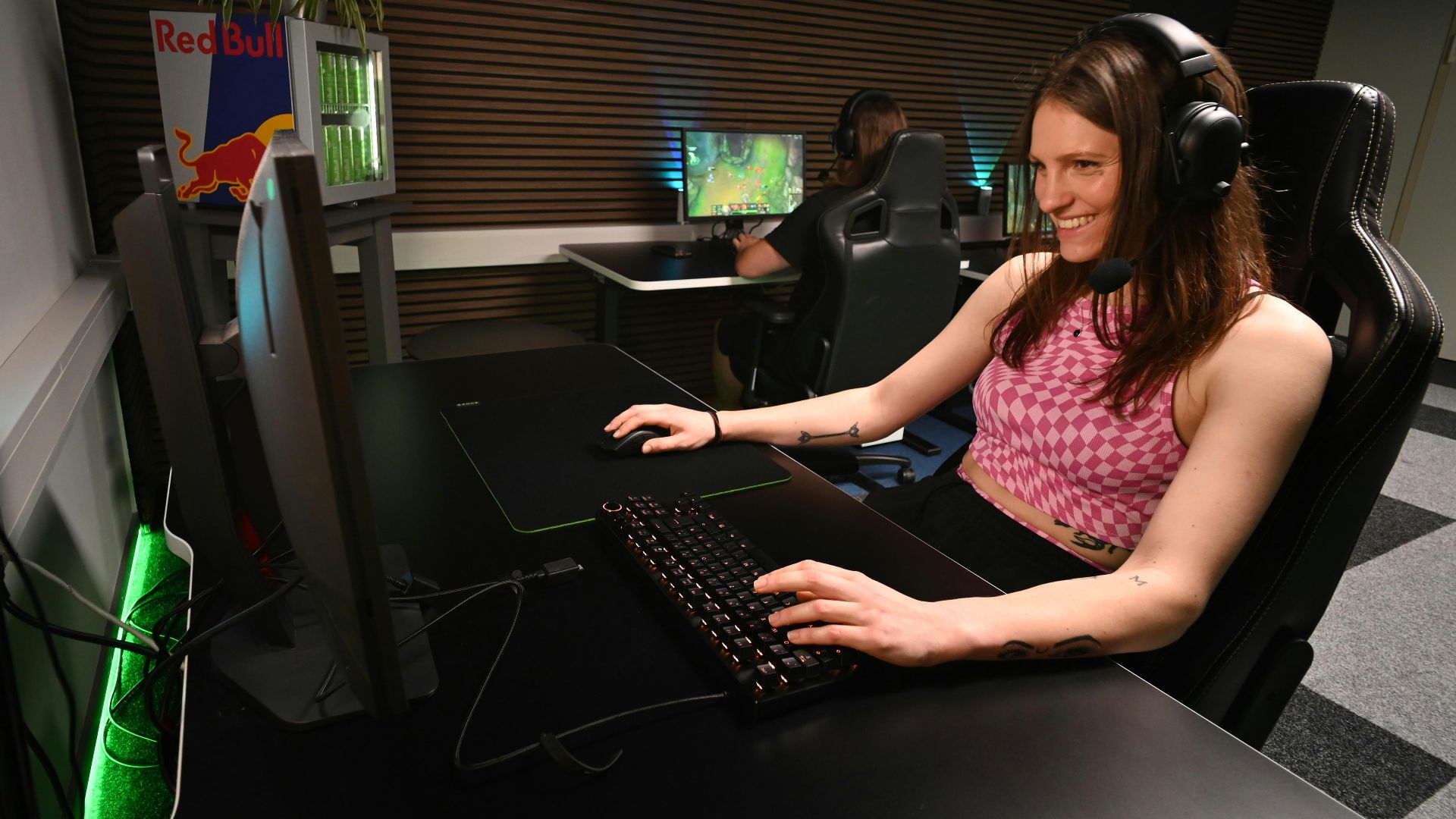 A woman sitting at a desk with headphones on