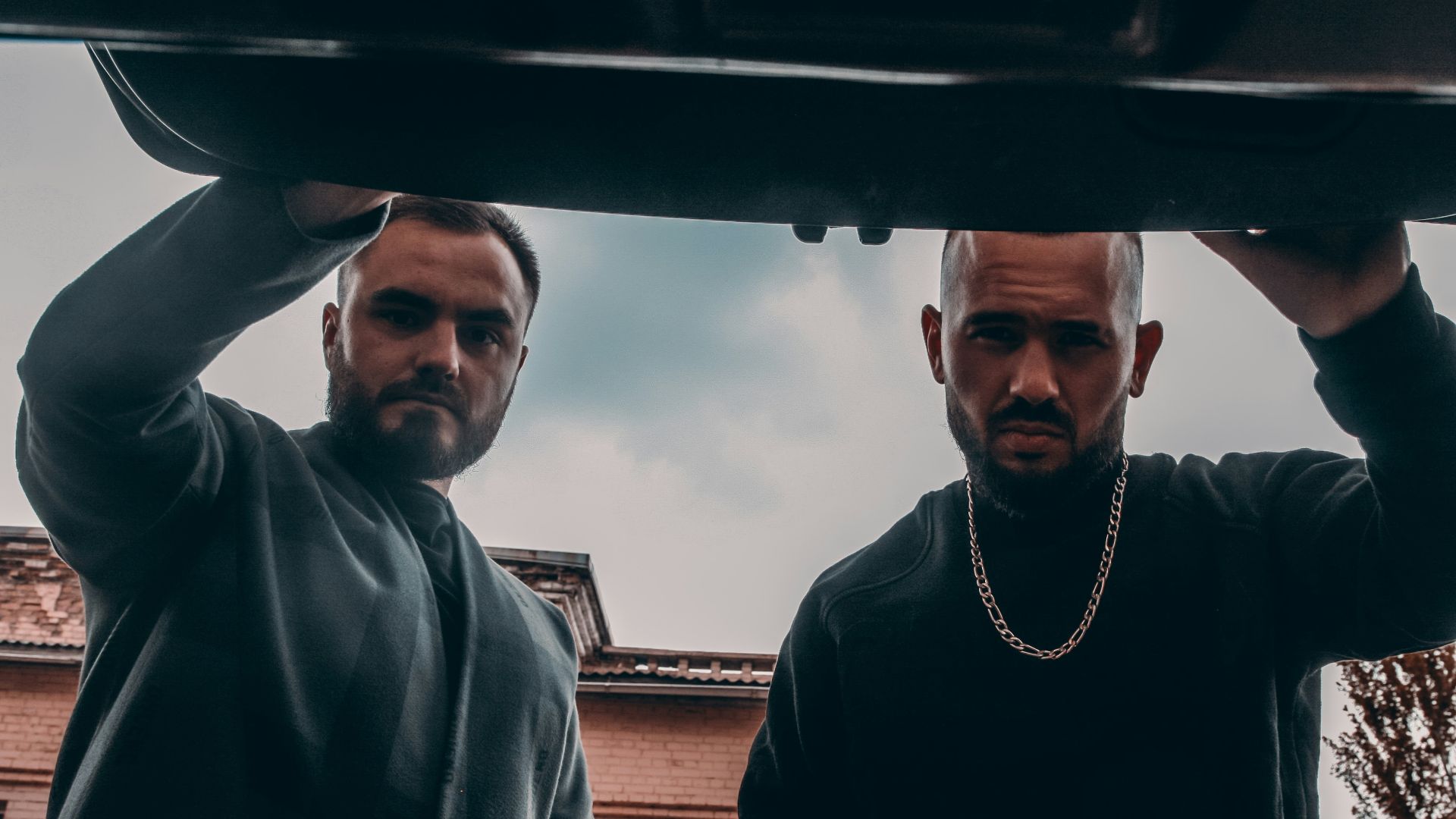 man in black zip up jacket wearing white earbuds