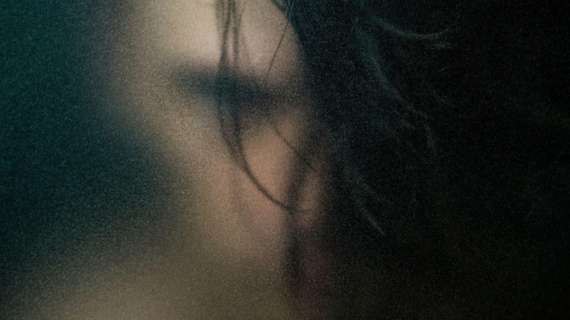 womans black hair on blue textile