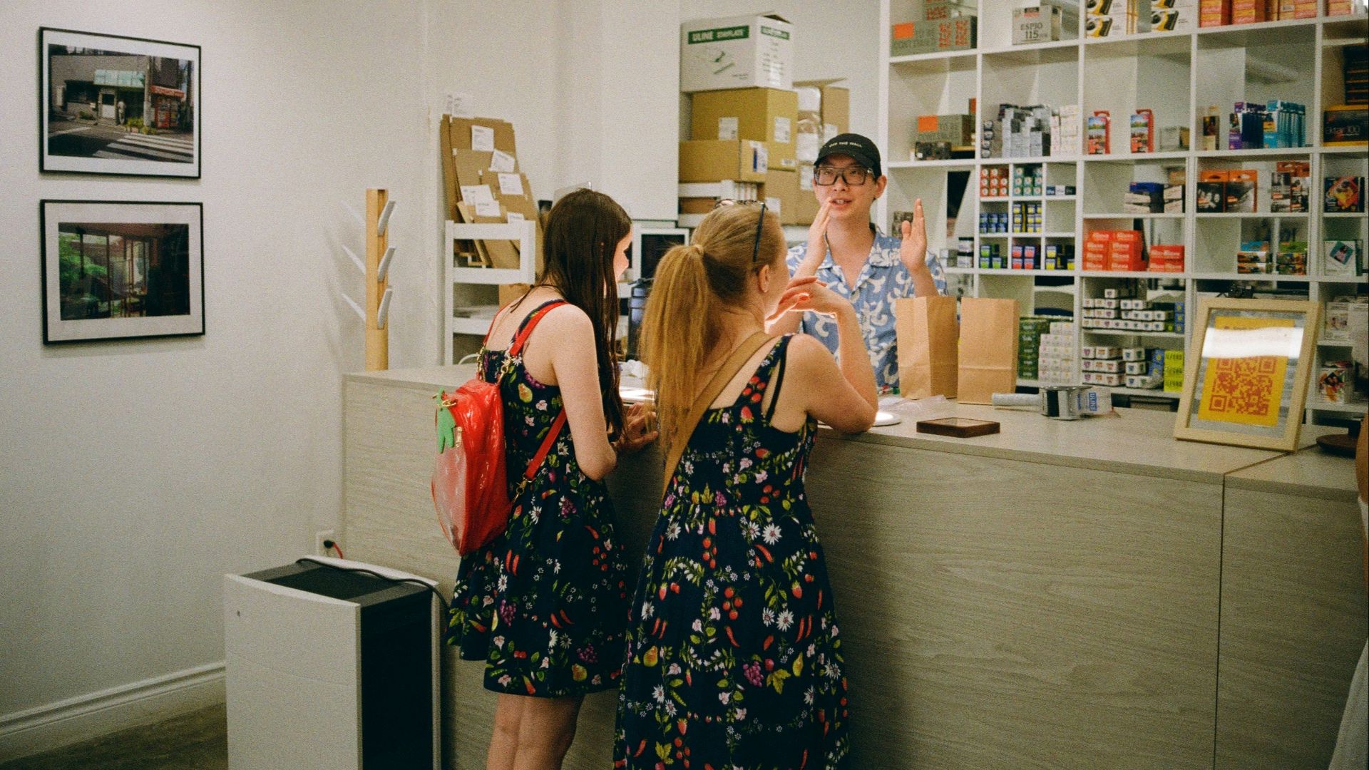 Customers are at the counter, being assisted by an employee.