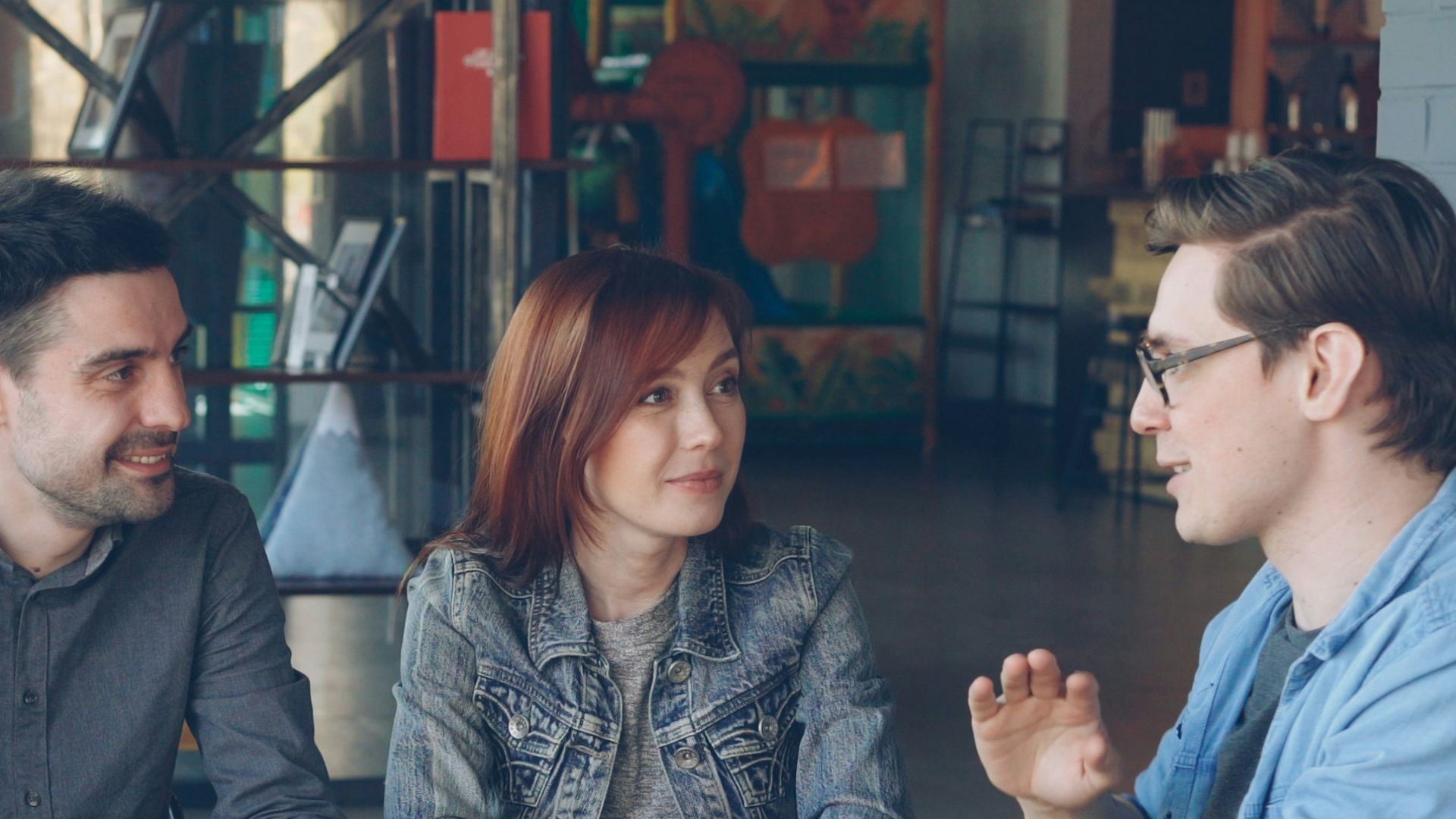 Friends chat and enjoy coffee at a cafe.