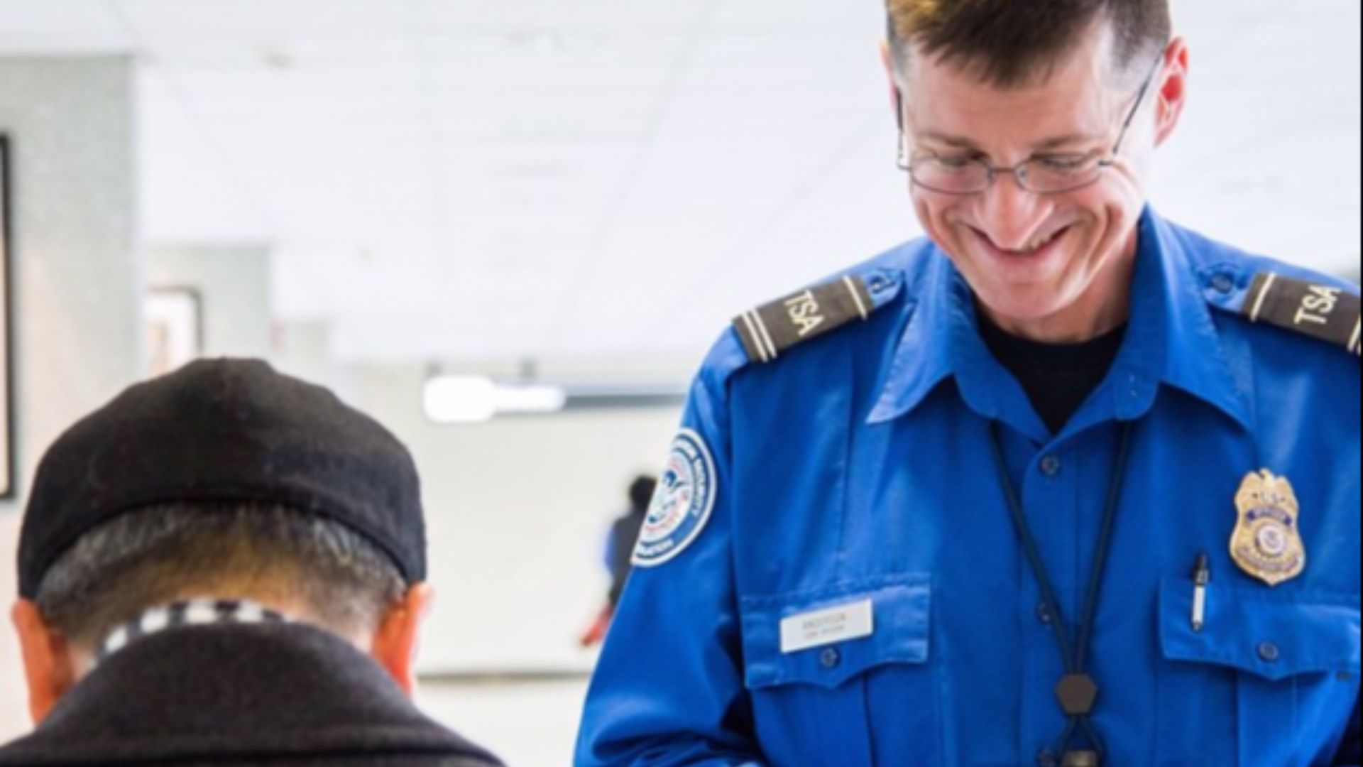 File:TSA Officer Checking ID.png