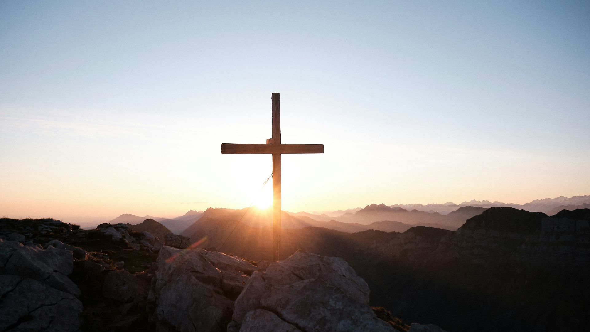 brown cross on brown rock during daytime