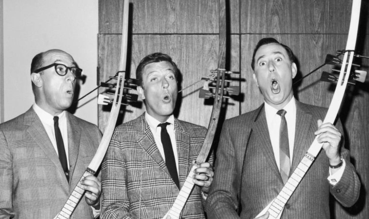  A promotional portrait for the television series 'The Dick Van Dyke Show', featuring (left to right) American actors Richard Deacon (1921 - 1984), Dick Van Dyke and Carl Reiner playing musical instruments call treholipees, circa 1963. Reiner also produced, directed and wrote for the series.