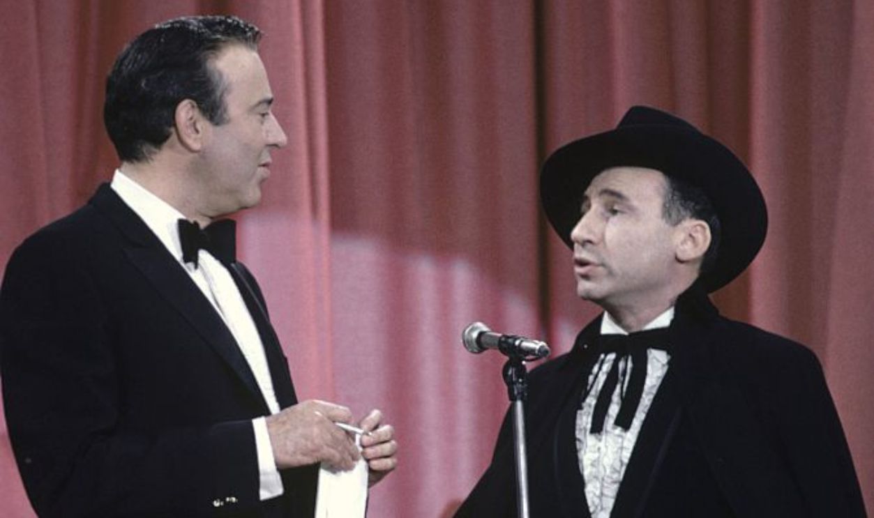 LOS ANGELES, CA - CIRCA 1967: Comedians, writers and directors Carl Reiner (1922-2020) and Mel Brooks perform their routine 'The 2000 Year Old Man' circa 1967 in Los Angeles, California. 