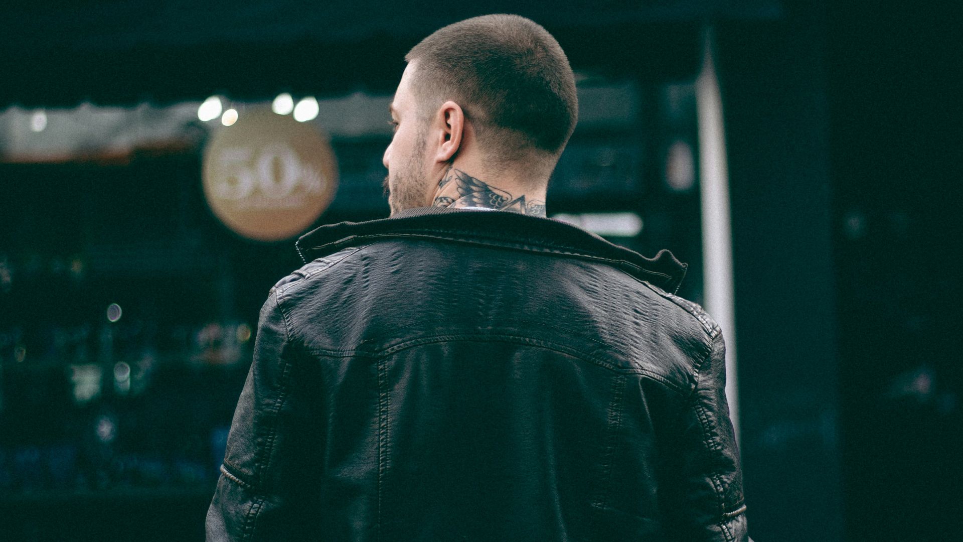man wearing black leather jacket
